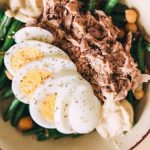 Delicious protein-packed bowl featuring tuna, boiled eggs, green beans, and hummus.